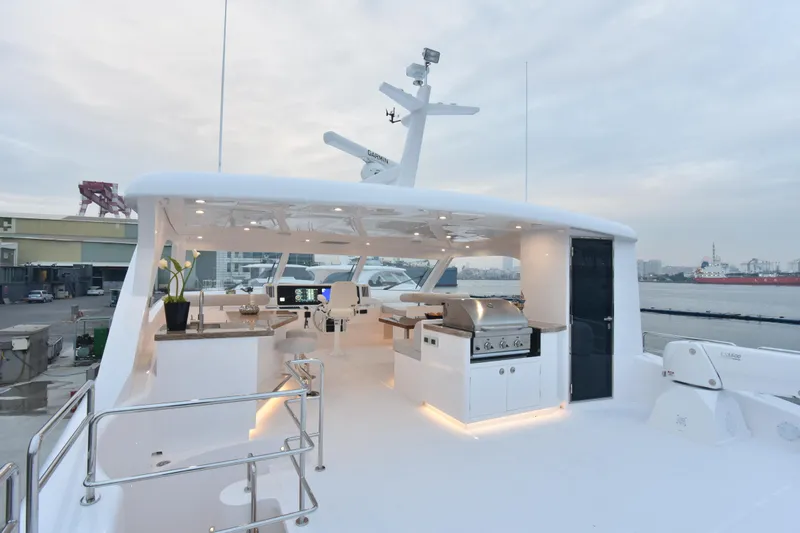 Hideout Yacht Photos Pics Luxurious 2022 Horizon PC65 yacht deck with modern amenities and waterfront view.
