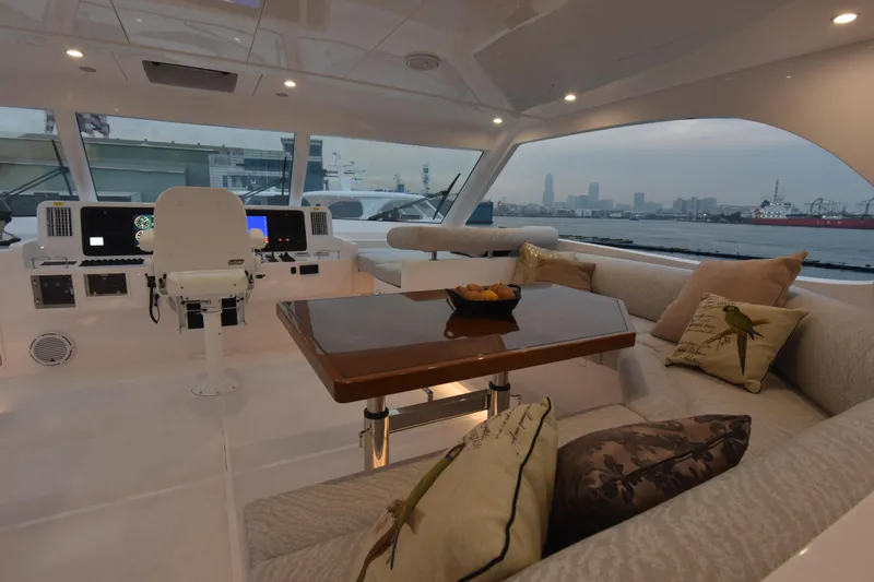 Hideout Yacht Photos Pics Luxurious 2022 Horizon PC65 yacht interior with plush seating and elegant dining area.
