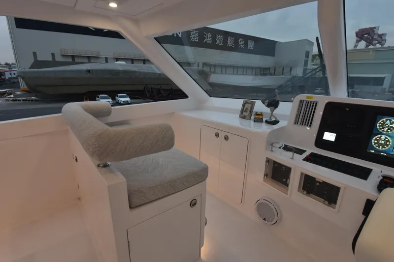 Hideout Yacht Photos Pics Interior of a 2022 Horizon PC65 yacht cockpit with modern controls and seating.