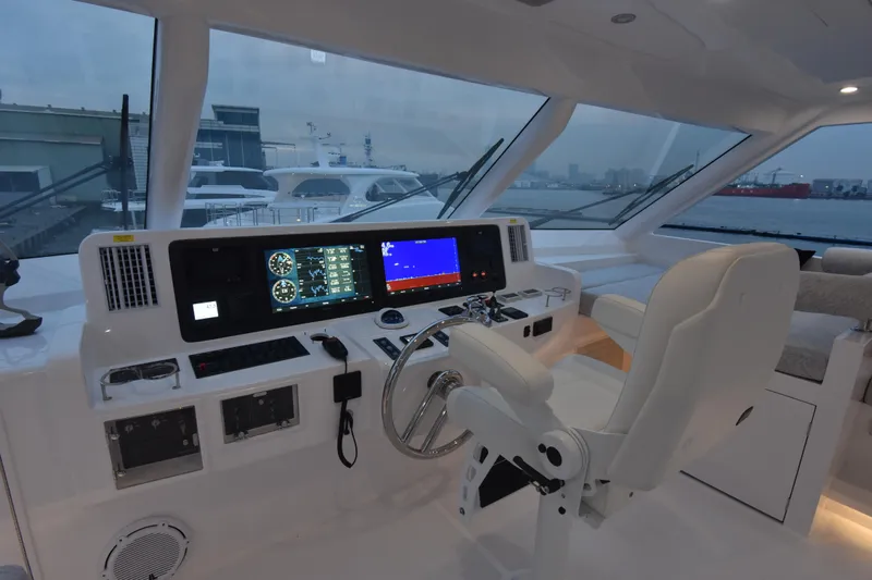 Hideout Yacht Photos Pics Luxurious 2022 Horizon PC65 yacht helm with advanced navigation systems and panoramic windows.
