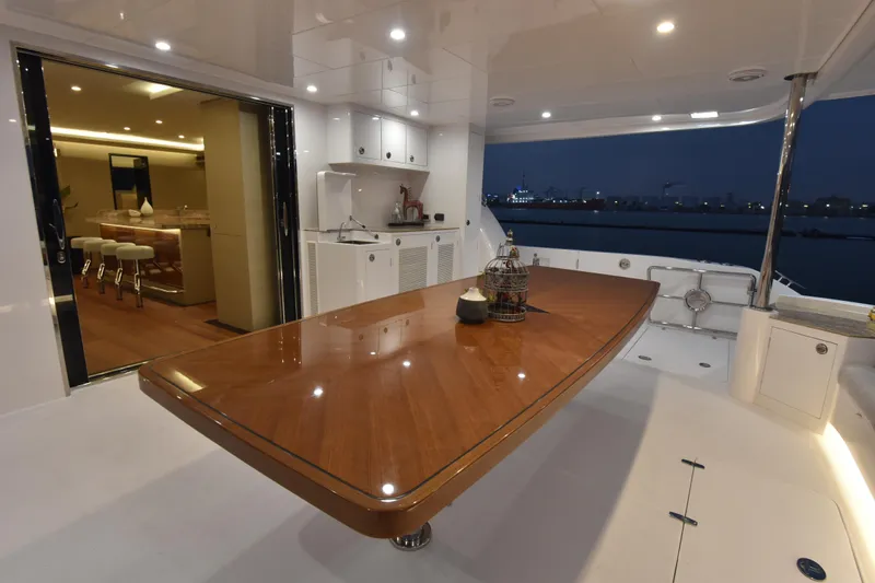 Hideout Yacht Photos Pics Luxurious Horizon PC65 yacht interior with elegant dining area and modern kitchen, 2022 model.