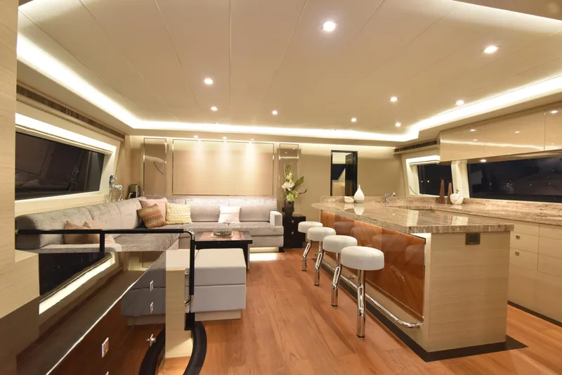 Hideout Yacht Photos Pics Luxurious interior of 2022 Horizon PC65 yacht with modern seating and elegant lighting.