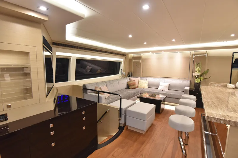 Hideout Yacht Photos Pics Luxurious interior of 2022 Horizon PC65 yacht with modern seating and elegant lighting.