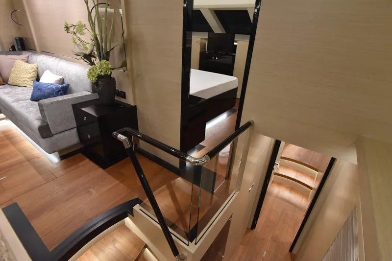 Hideout Yacht Photos Pics Luxurious interior of 2022 Horizon PC65 yacht with modern decor and elegant staircase.