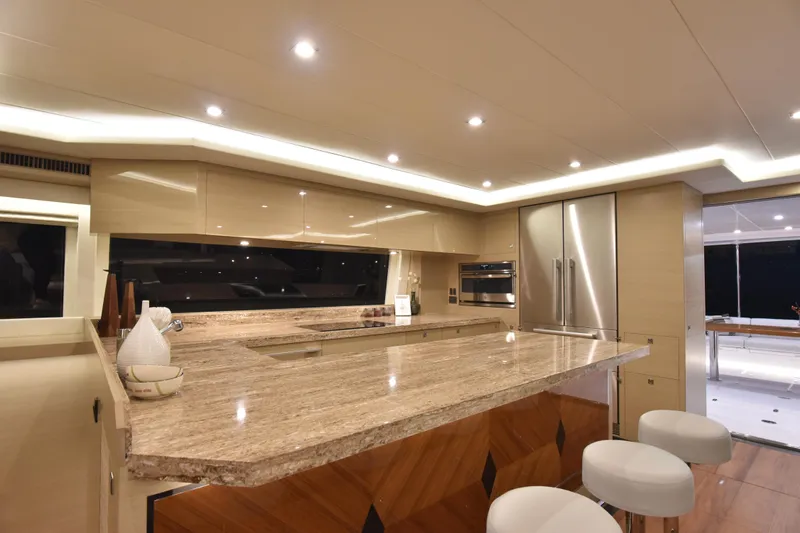 Hideout Yacht Photos Pics Luxurious kitchen interior on 2022 Horizon PC65 yacht with modern design and marble countertops.