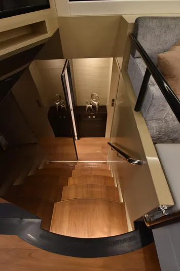 Hideout Yacht Photos Pics Staircase in 2022 Horizon PC65 yacht interior with modern design and wooden steps.