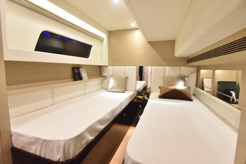 Hideout Yacht Photos Pics Luxurious cabin interior of 2022 Horizon PC65 yacht with twin beds and modern decor.