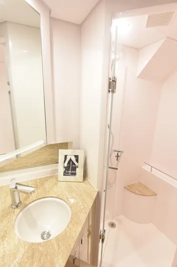 Hideout Yacht Photos Pics Modern bathroom in 2022 Horizon PC65 yacht with sleek sink and glass shower.