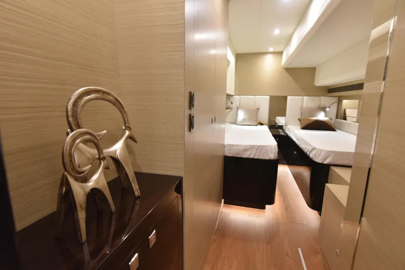 Hideout Yacht Photos Pics Luxurious cabin interior of 2022 Horizon PC65 yacht with elegant decor and twin beds.