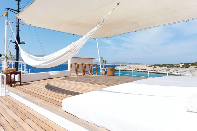 Hayama Yacht Photos Pics Luxurious yacht deck with hammock, sunbeds, and ocean view, Custom Hakodate Shipyard, 1988.