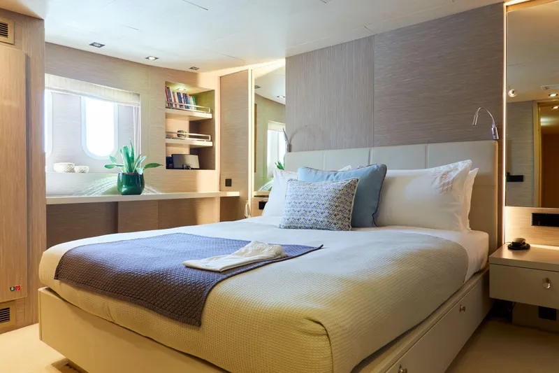 Hayama Yacht Photos Pics Luxurious yacht bedroom with modern decor, featuring a comfortable bed and elegant furnishings, 1988 Hakodate Shipyard.