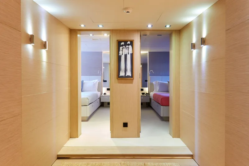 Hayama Yacht Photos Pics Luxurious ship interior with modern twin beds, soft lighting, and elegant wooden decor.