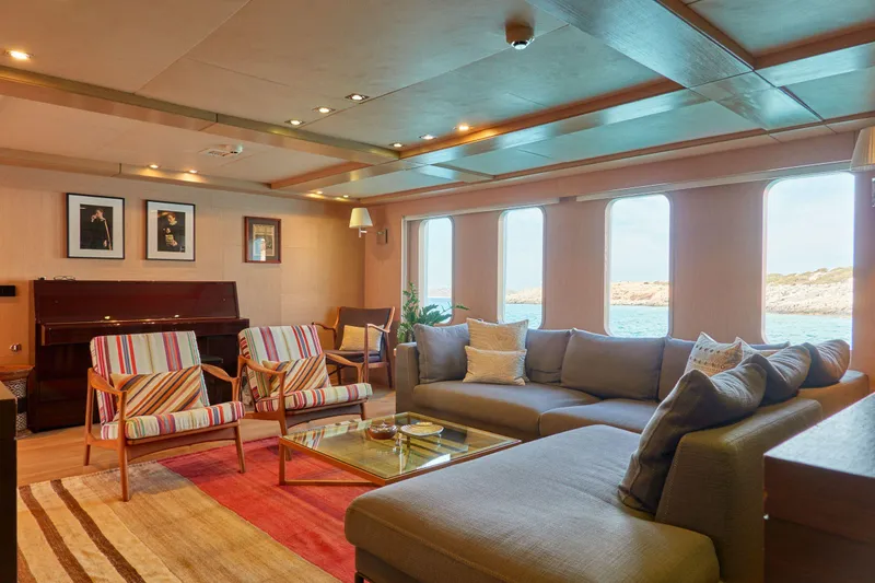 Hayama Yacht Photos Pics Luxurious ship interior with modern seating, piano, and ocean view, Custom Hakodate Shipyard, 1988.