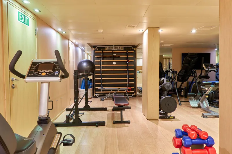 Hayama Yacht Photos Pics Modern gym with exercise equipment, including stationary bikes and weights, on a ship built in 1988.