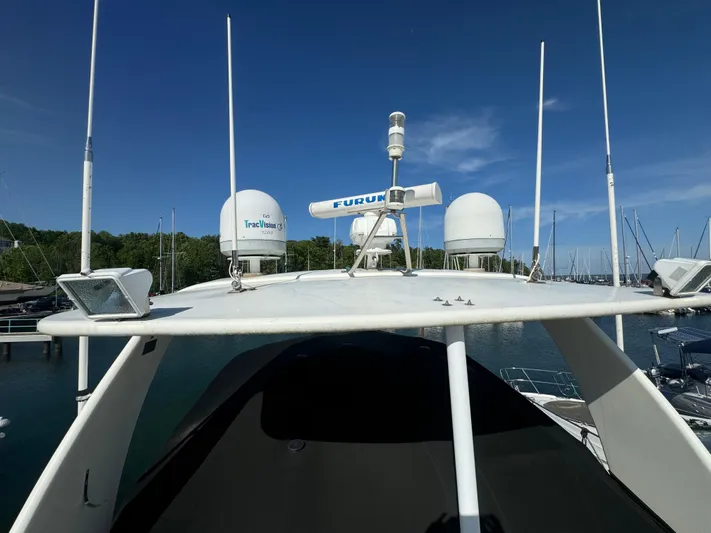 Tenacious Yacht Photos Pics 2003 Cruisers Yachts 5000 Sedan Sport with radar equipment, docked in a marina under clear skies.