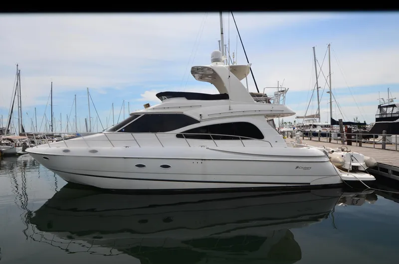 Tenacious Yacht Photos Pics 2003 Cruisers Yachts 5000 Sedan Sport docked at marina, side view.