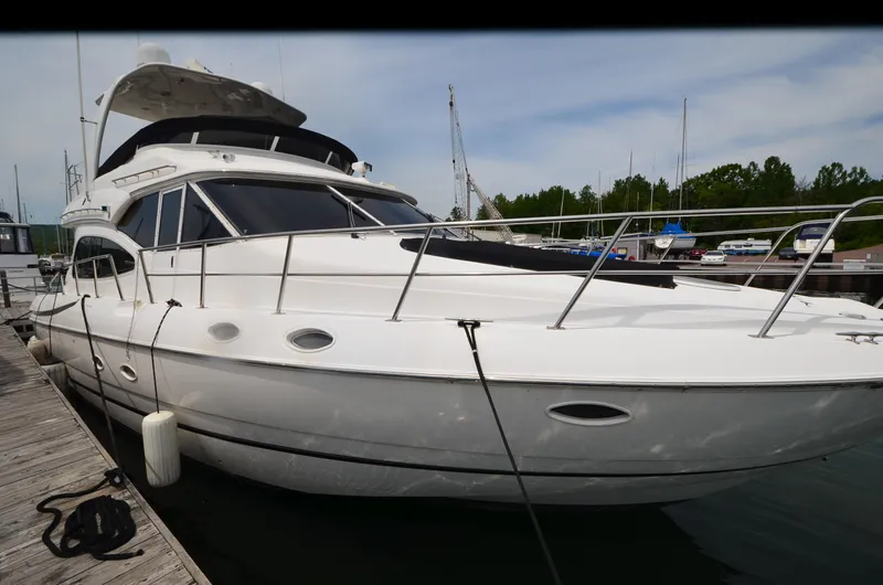 Tenacious Yacht Photos Pics 2003 Cruisers Yachts 5000 Sedan Sport docked at marina.