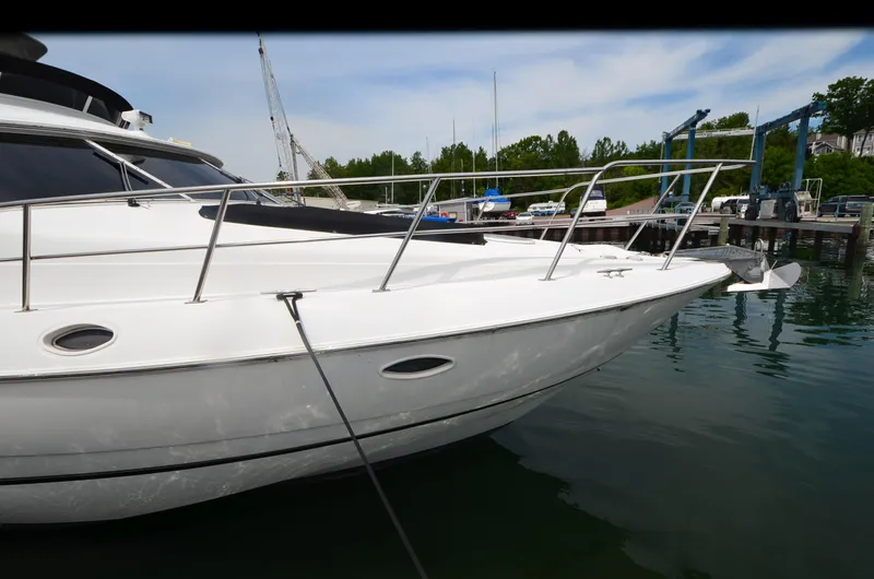 Tenacious Yacht Photos Pics 2003 Cruisers Yachts 5000 Sedan Sport docked at marina, side view.
