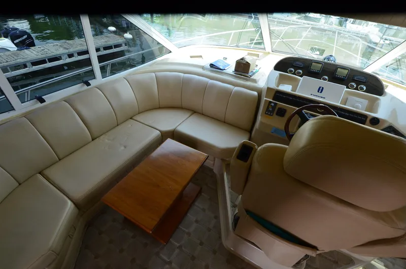 Tenacious Yacht Photos Pics Luxurious interior of 2003 Cruisers Yachts 5000 Sedan Sport with leather seating and helm.