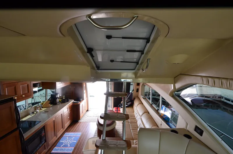 Tenacious Yacht Photos Pics Interior of 2003 Cruisers Yachts 5000 Sedan Sport, featuring kitchen and seating area.