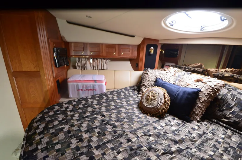 Tenacious Yacht Photos Pics Luxurious cabin interior of 2003 Cruisers Yachts 5000 Sedan Sport with stylish bedding.