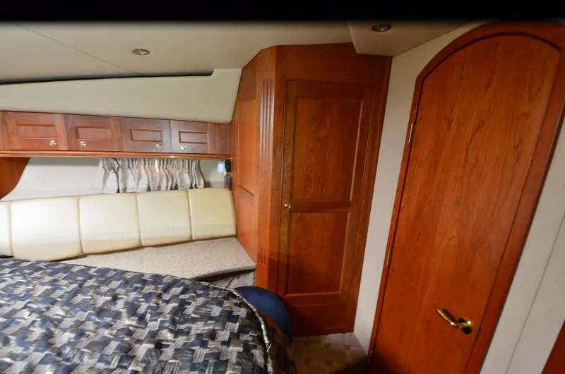 Tenacious Yacht Photos Pics Interior of 2003 Cruisers Yachts 5000 Sedan Sport with wood paneling and cozy seating.