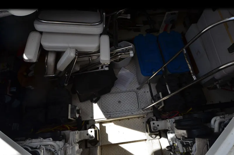 Tenacious Yacht Photos Pics Engine room of 2003 Cruisers Yachts 5000 Sedan Sport with equipment and storage items.