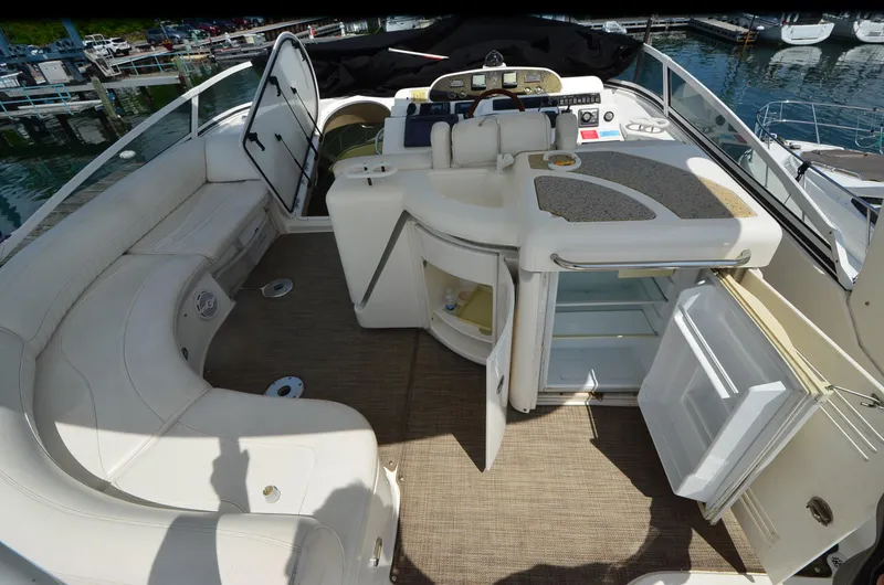 Tenacious Yacht Photos Pics 2003 Cruisers Yachts 5000 Sedan Sport interior with seating and open storage compartments.