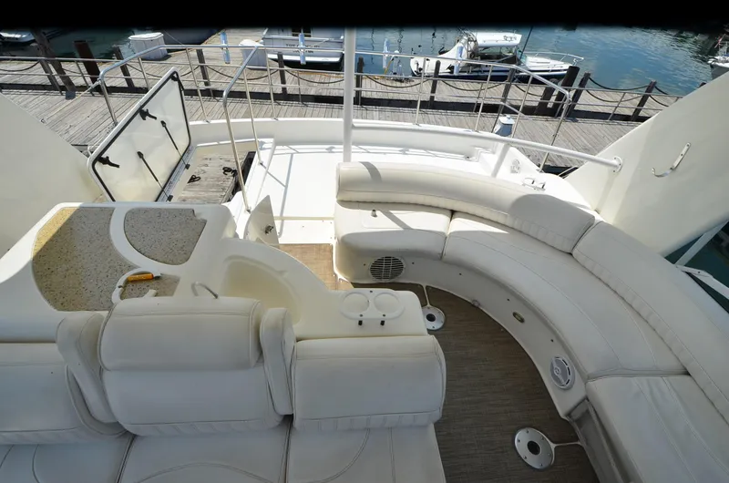 Tenacious Yacht Photos Pics 2003 Cruisers Yachts 5000 Sedan Sport interior with white seating and deck view.