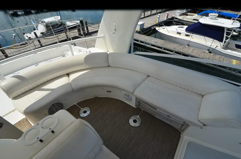 Tenacious Yacht Photos Pics 2003 Cruisers Yachts 5000 Sedan Sport interior with white seating and marina view.