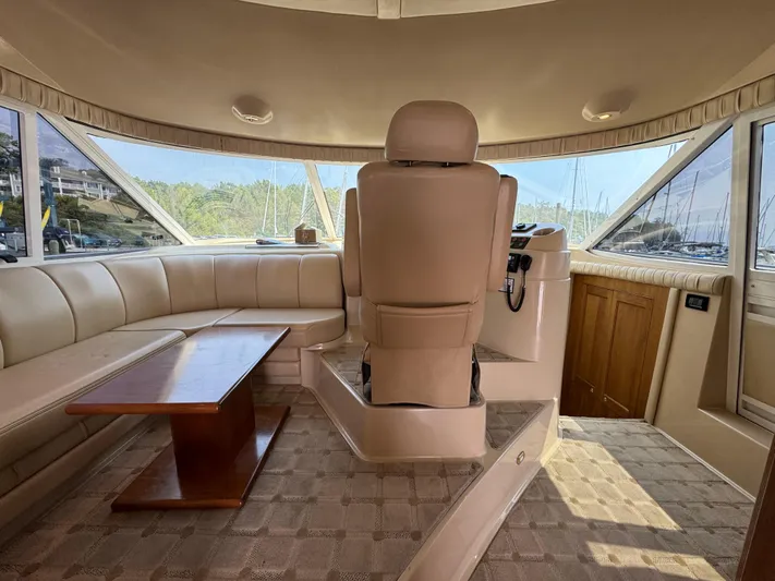 Tenacious Yacht Photos Pics Interior of 2003 Cruisers Yachts 5000 Sedan Sport with beige seating and helm.