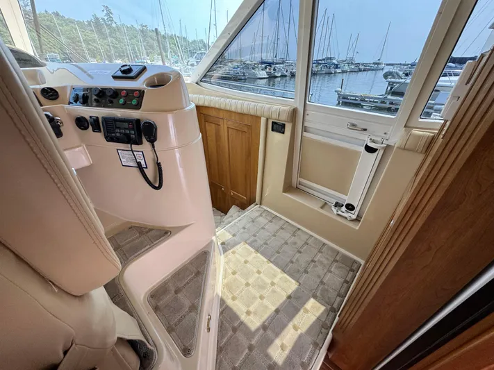 Tenacious Yacht Photos Pics Interior helm of 2003 Cruisers Yachts 5000 Sedan Sport, overlooking marina.