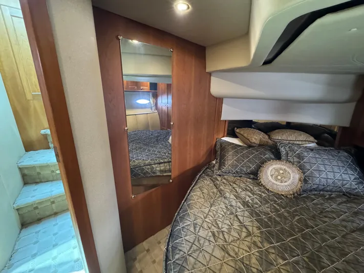Tenacious Yacht Photos Pics Luxurious bedroom interior of 2003 Cruisers Yachts 5000 Sedan Sport with elegant bedding.