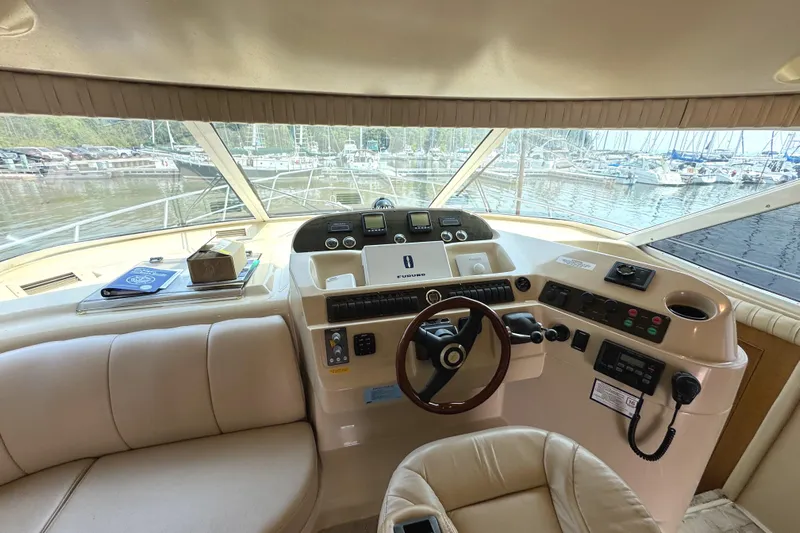 Tenacious Yacht Photos Pics 2003 Cruisers Yachts 5000 Sedan Sport helm with marina view.