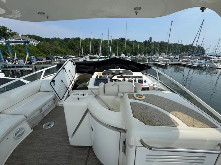 Tenacious Yacht Photos Pics 2003 Cruisers Yachts 5000 Sedan Sport at marina, featuring helm and seating area.