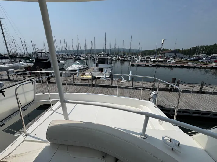Tenacious Yacht Photos Pics 2003 Cruisers Yachts 5000 Sedan Sport docked at a marina with other boats.