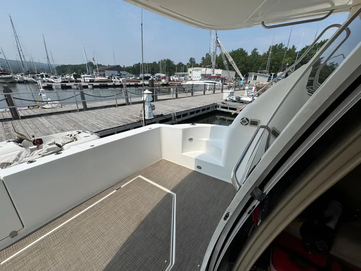 Tenacious Yacht Photos Pics 2003 Cruisers Yachts 5000 Sedan Sport docked at marina, showing deck and stairs.