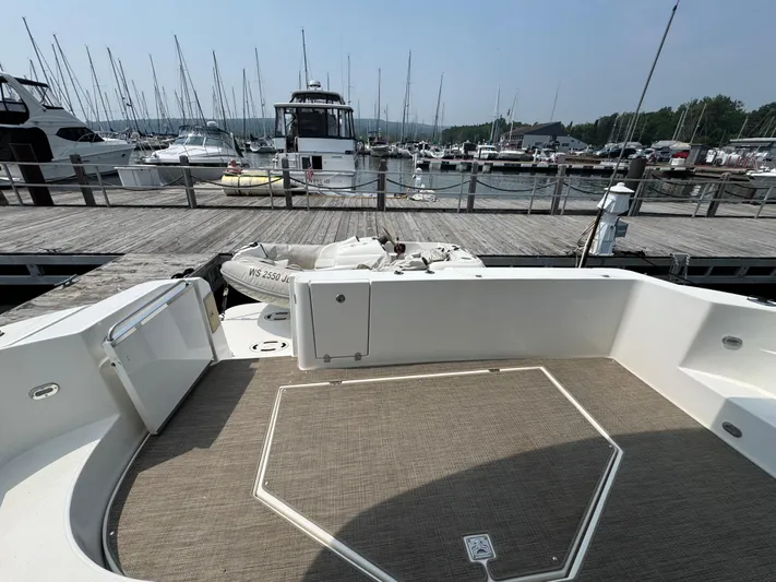 Tenacious Yacht Photos Pics 2003 Cruisers Yachts 5000 Sedan Sport docked at marina with other boats.