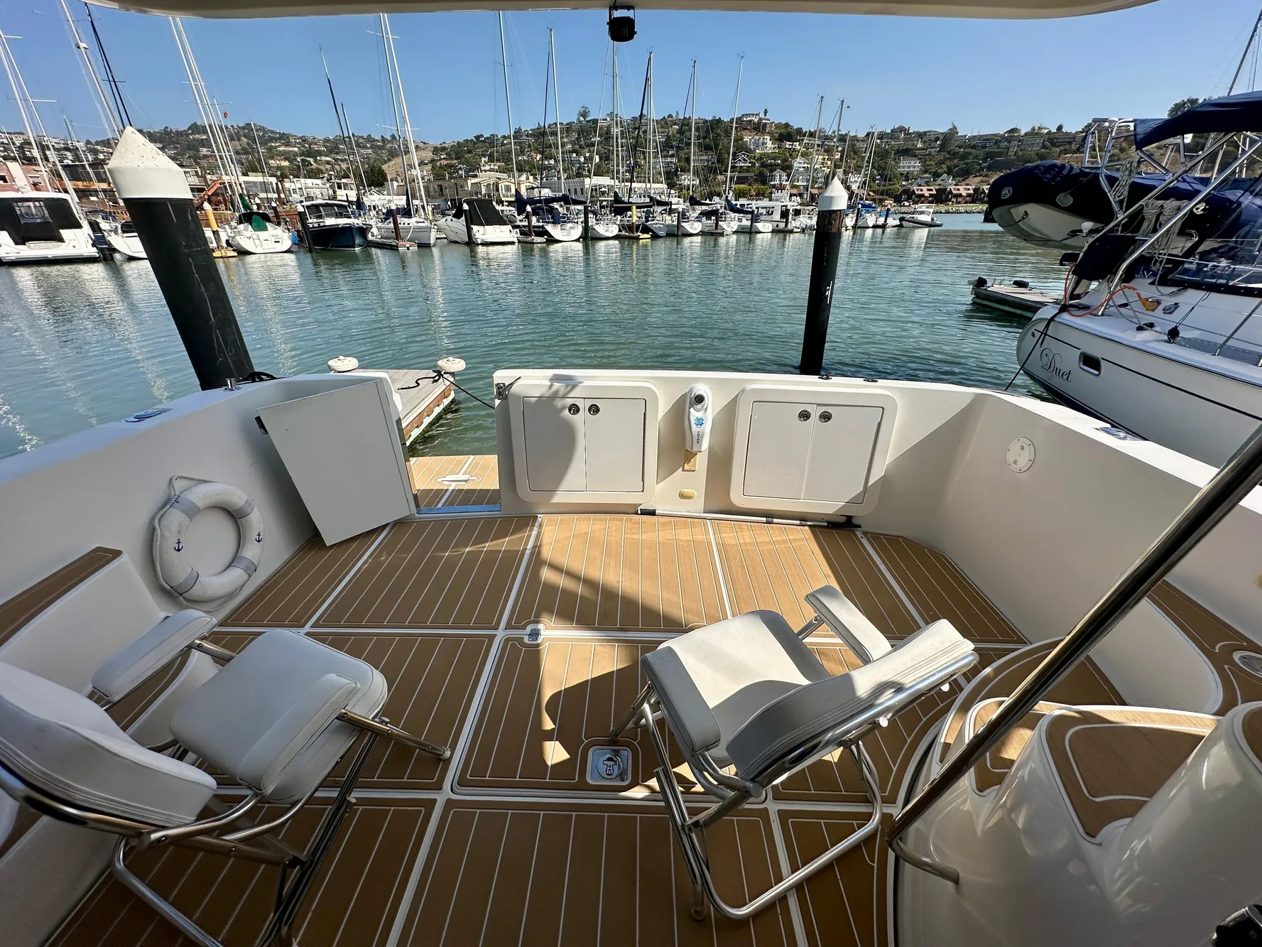 2008 Carver 43 Super Sport yacht deck with chairs, docked at marina.