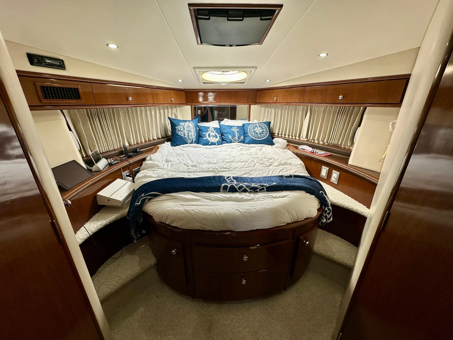 Luxurious bedroom interior of 2008 Carver 43 Super Sport yacht with elegant bedding.