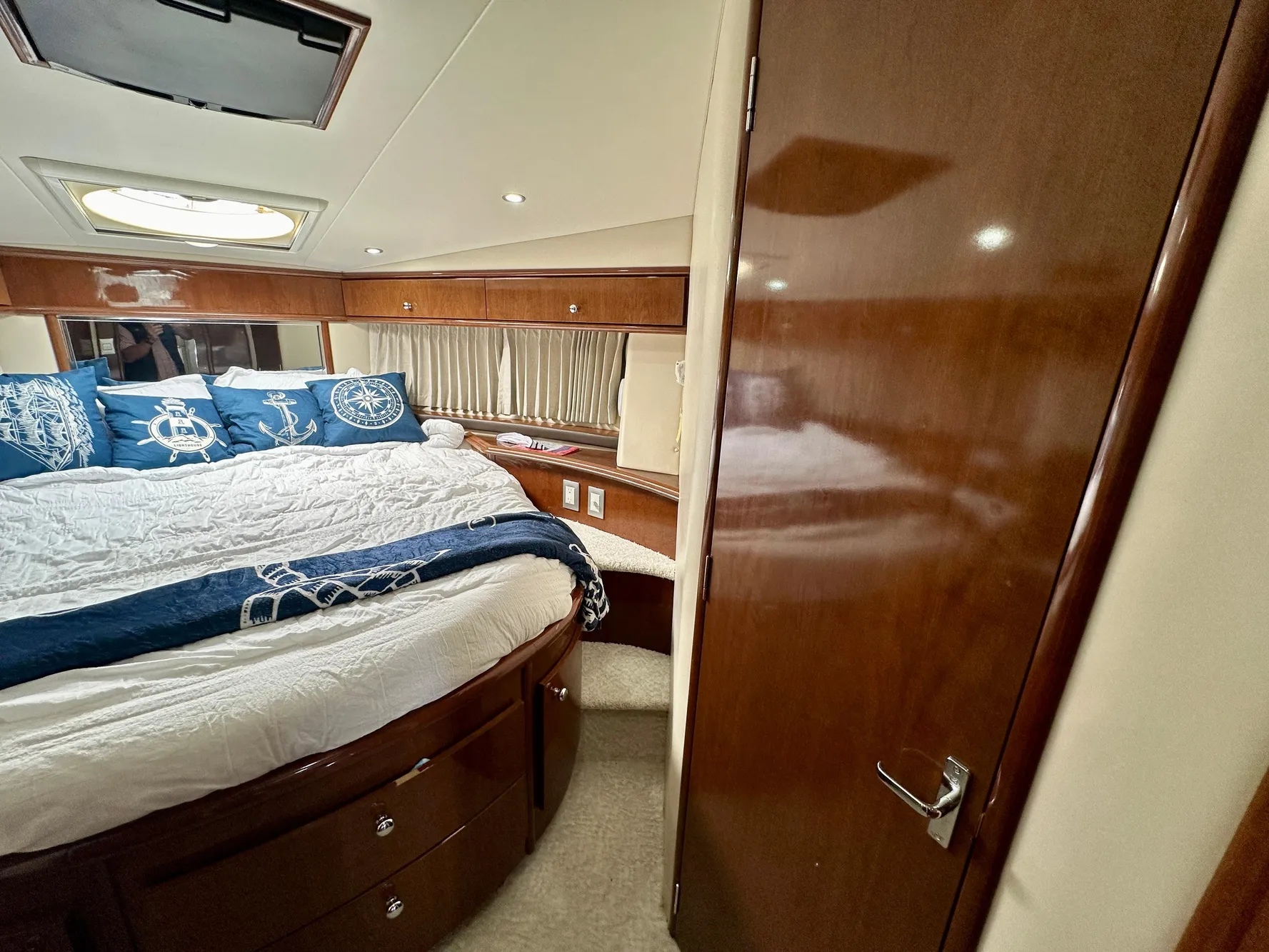 Luxurious bedroom interior of 2008 Carver 43 Super Sport yacht with elegant wood finishes.