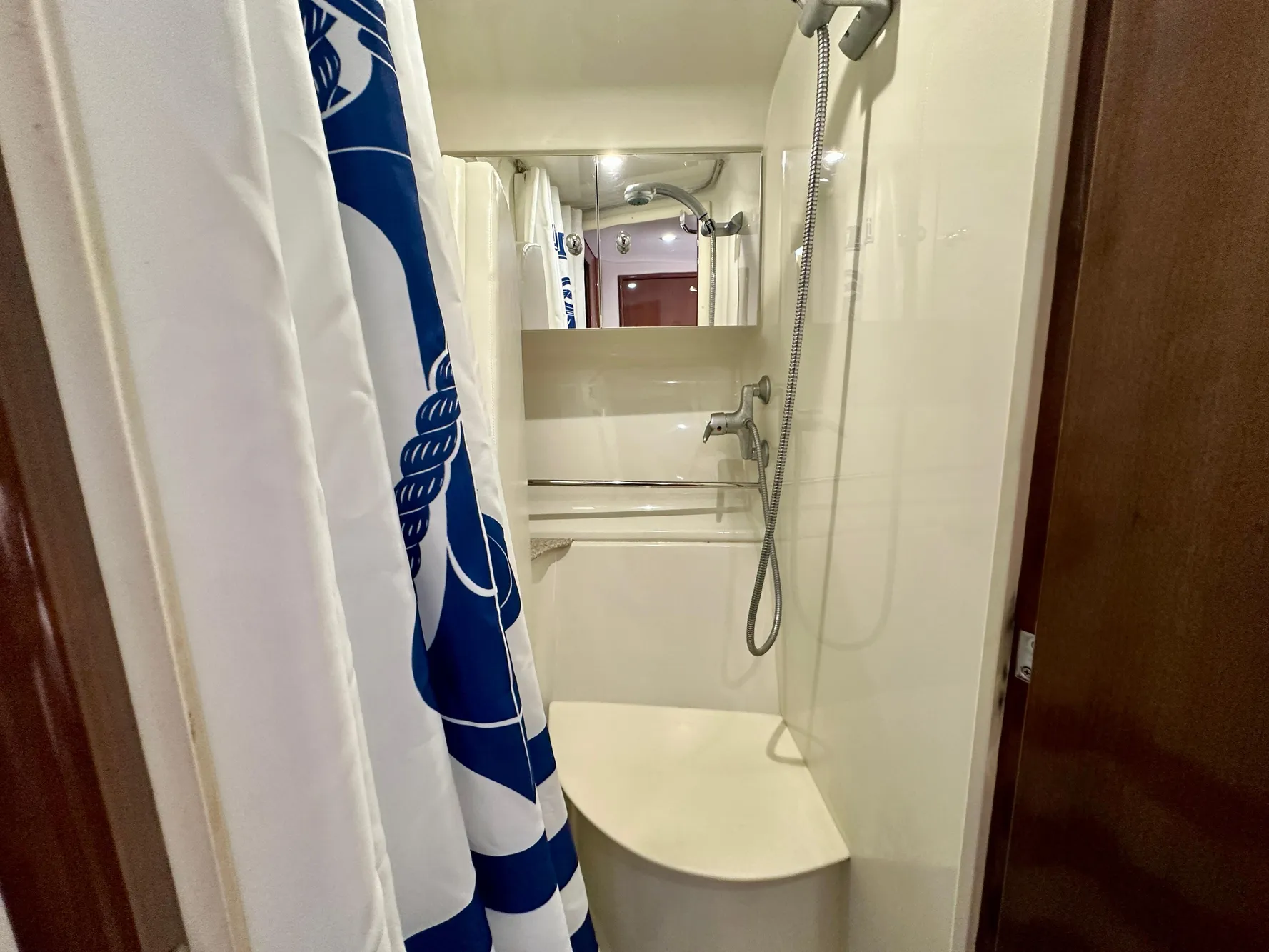 Shower area in 2008 Carver 43 Super Sport yacht with blue and white curtain.
