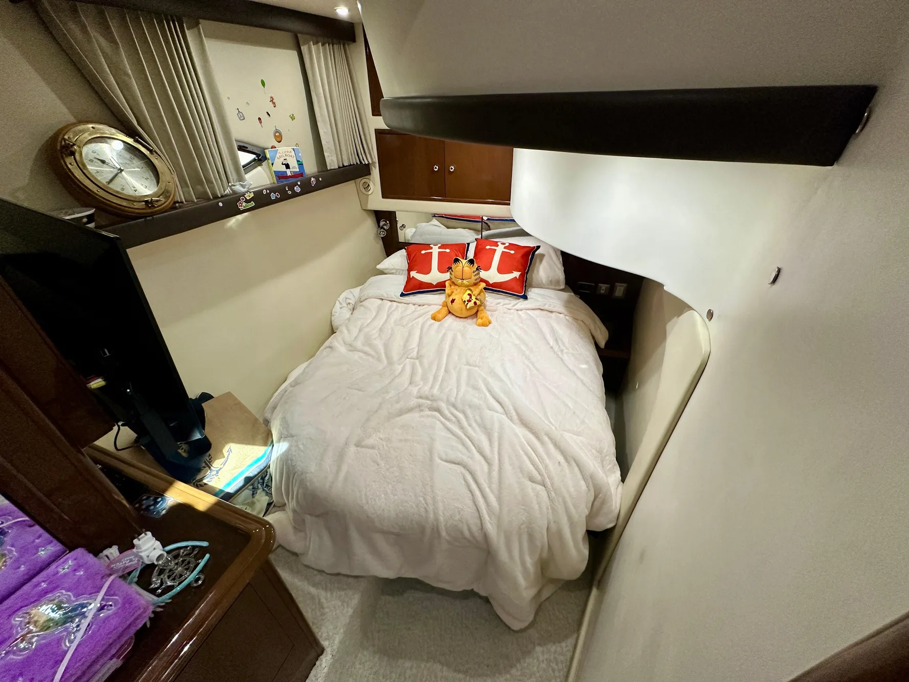 Cozy bedroom in 2008 Carver 43 Super Sport yacht with plush bedding and decorative pillows.