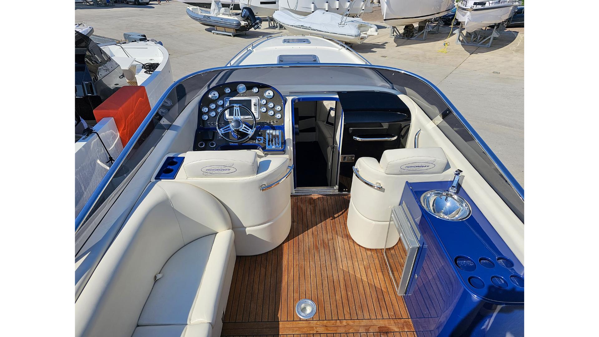 Luxurious 2010 Performance 1107 boat interior with sleek dashboard and comfortable seating.