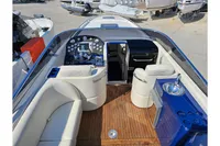 Luxurious 2010 Performance 1107 boat interior with sleek dashboard and comfortable seating.
