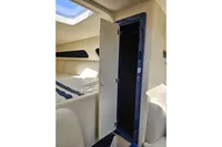 Interior cabin of 2010 Performance 1107 boat with open storage compartment.