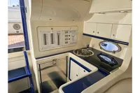 Compact yacht kitchen with control panel, sink, and storage. Performance 1107, 2010 model.