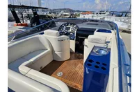 Luxurious 2010 Performance 1107 boat interior with plush seating and sleek dashboard.