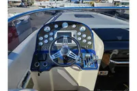 Steering console of a 2010 Performance 1107 boat with gauges and controls.