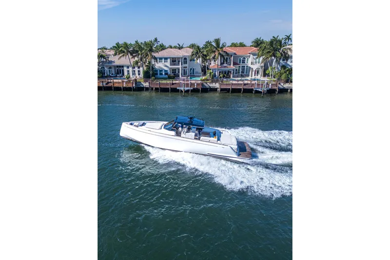  Yacht Photos Pics 2019 Pardo Yachts P50 cruising near waterfront homes on a sunny day.